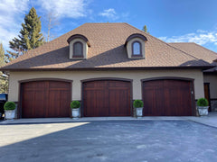 Triple car garage with perfectly placed topiary balls